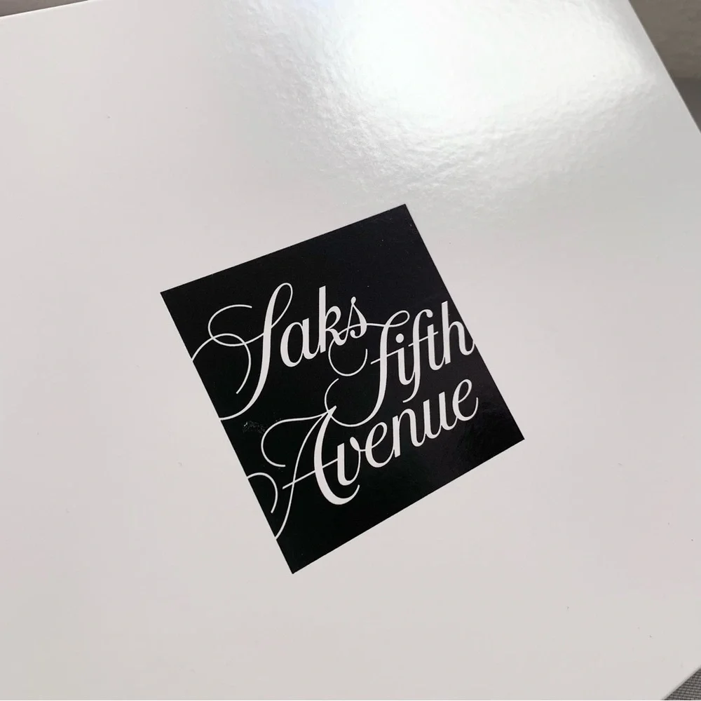 Hold Saks Fifth Avenue gift boxes